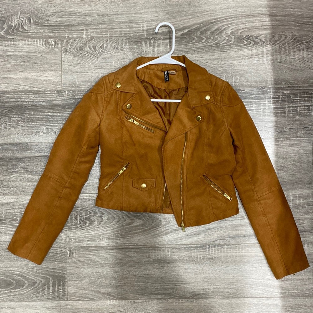 Faux brown leather jacket with zippers on sleeves.